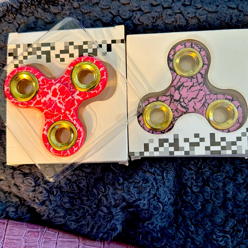 One set of two NWT brand new fidget spinners 1 pink one purple both for 20 bucks